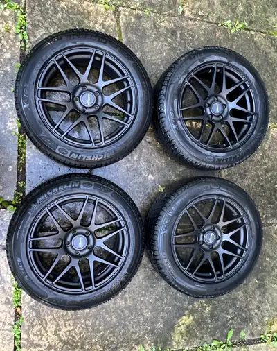 Set of four 225/55R18 Michelin X-Ice tires on Klasse Apex matte black rims. Very good condition with...