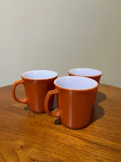 Set of 3 vintage PYREX mugs in an autumnal burnt orange colour with white inside. Milk Glass with D...