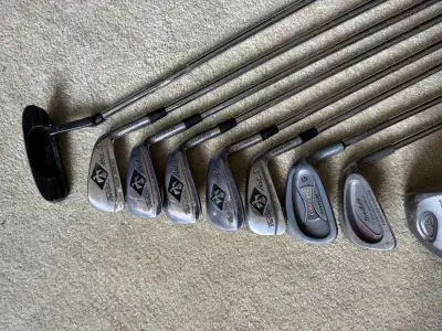A set of golf clubs with a bag and balls, View more