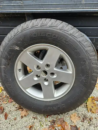 Cooper Discoverer Snow Claw tires. 265/70R17 mounted on Jeep aluminum rims. Less than 1,000 kms on t...