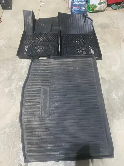 Rubber floor mats, custom cut and formed for 2 front seats and large rear mat. In good condition, cl...