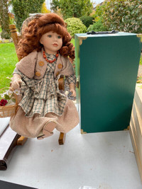Collectible porcelain doll with rocking chair and case