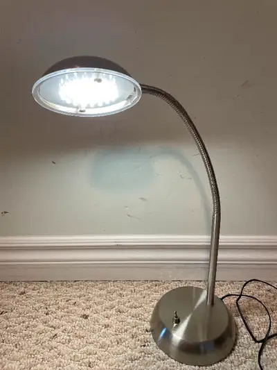 Flexible silver desk lamp. Bright warm white light. Modern, convenient adjustable lamp. Versatile an...