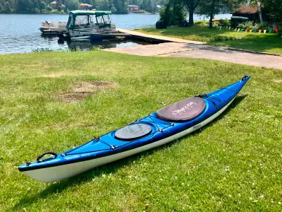 This is a lightweight, responsive 14 ft fiberglass Impex Sea Breeze kayak designed with smaller padd...