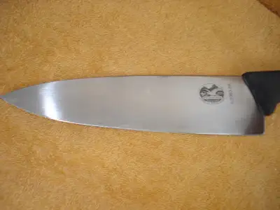 8" blade; blade is shiny what appear to be discolorations in photos are reflections