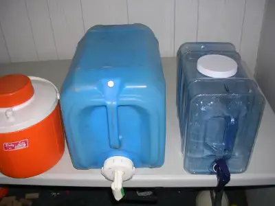 19 litre heavy duty water jug 2 gallon coleman thermos and a plastic jug, all in good cond. $10 for...
