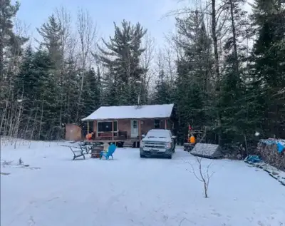 Escape to peace and privacy with this fully equipped off-grid hunting cabin, nestled on a beautifull...