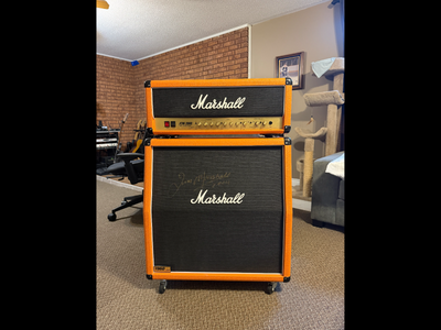 Marshall 50 watt DSL Amp & Cab with orange tolex. Cabinet is signed by Jim Marshall. The unit was bo...