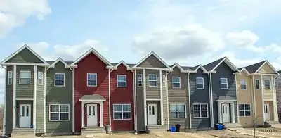 Middle gray townhome in picture. Check out this Charming & Spacious 4-Bedroom Townhouse in Steinbach...