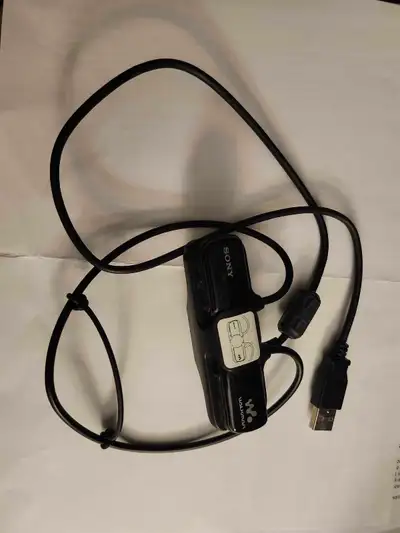 Black Sony Walkman W Series MP3 player with integrated earbuds. Includes USB charging cable. Great f...