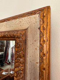 An Antique mirror with the frame