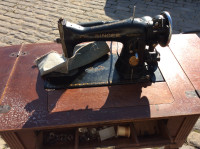 Singer sewing machine with walnut cabinet...