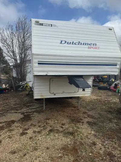 2003 Dutchman 5 th wheel been redone inside new futon couch bar table with 3 chairs fairly new mattr...