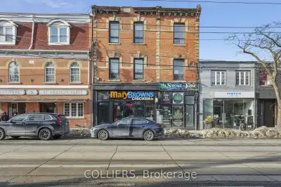 Newly constructed (2024) mixed-use (retail with 6 apartment units) building fronting on Queen Street...