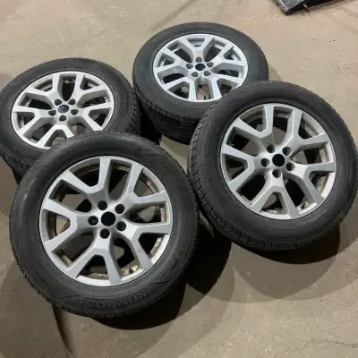 Set of four 235/60/18 Kumho Crugen Premium all season tires mounted and balanced on aftermarket alum...