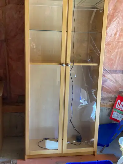 Glass door cabinet with light colored wood, View more