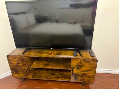 TV stand for up to 65 inches TV with charging station. It is slightly used. Dimensions 55.5x14.5x 22...