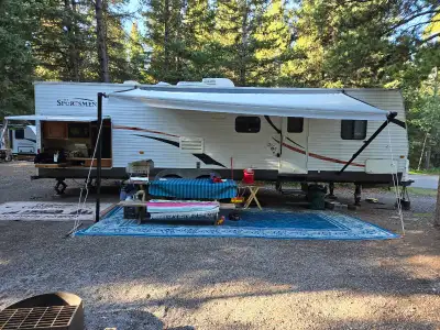 Trailer is 32ft long inside, 34ft bumper to hitch. 2 slides, full outdoor kitchen with hot and cold...