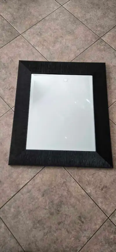 External frame 26.5" x 22.5" Mirror size 19.5" x 15.5" Beveled mirror Black frame
