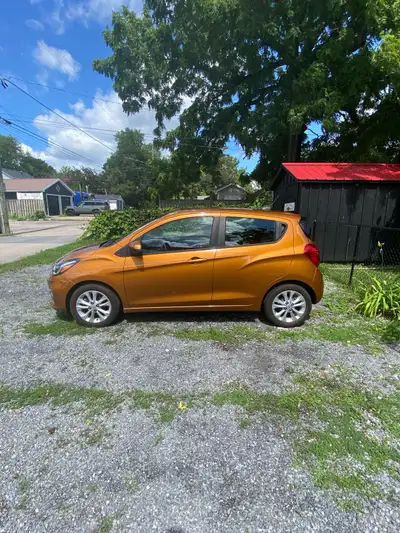 2020 Orange Burst Metallic Chevrolet Spark LT four-door hatchback with 15” silver multi-spoke alloy...