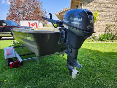 12" John Boat, like New. Still have the stickers, pedals, fishifinder, safety box, etc..8Hp Yamaha e...