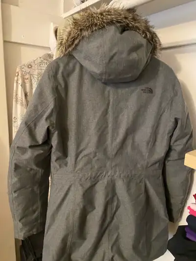 Its colored gray and a hood It fits only for women with Small size .