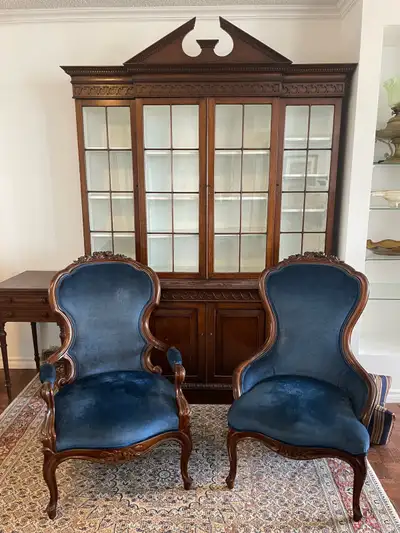 Beautiful matching set featuring two carved wood parlour chairs with rich royal blue velvet upholste...