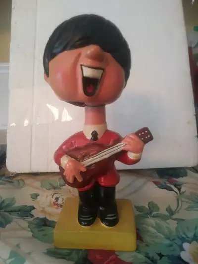 Beatles John Lennon Yeah Yeah Yeah Bobble Head With Yellow Square Base 1960's. Our bobble head is ab...
