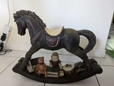 Hand painted rocking horse with toys . This is a collectable, not a toy. 16.5 inch high 20.5 inch wi...