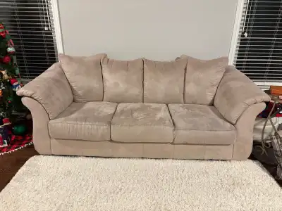This is a comfy tan suede couch, perfect for any living room! It's in good condition and quite cozy...