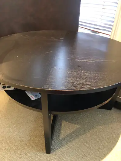 Black round coffee table still in good condition.