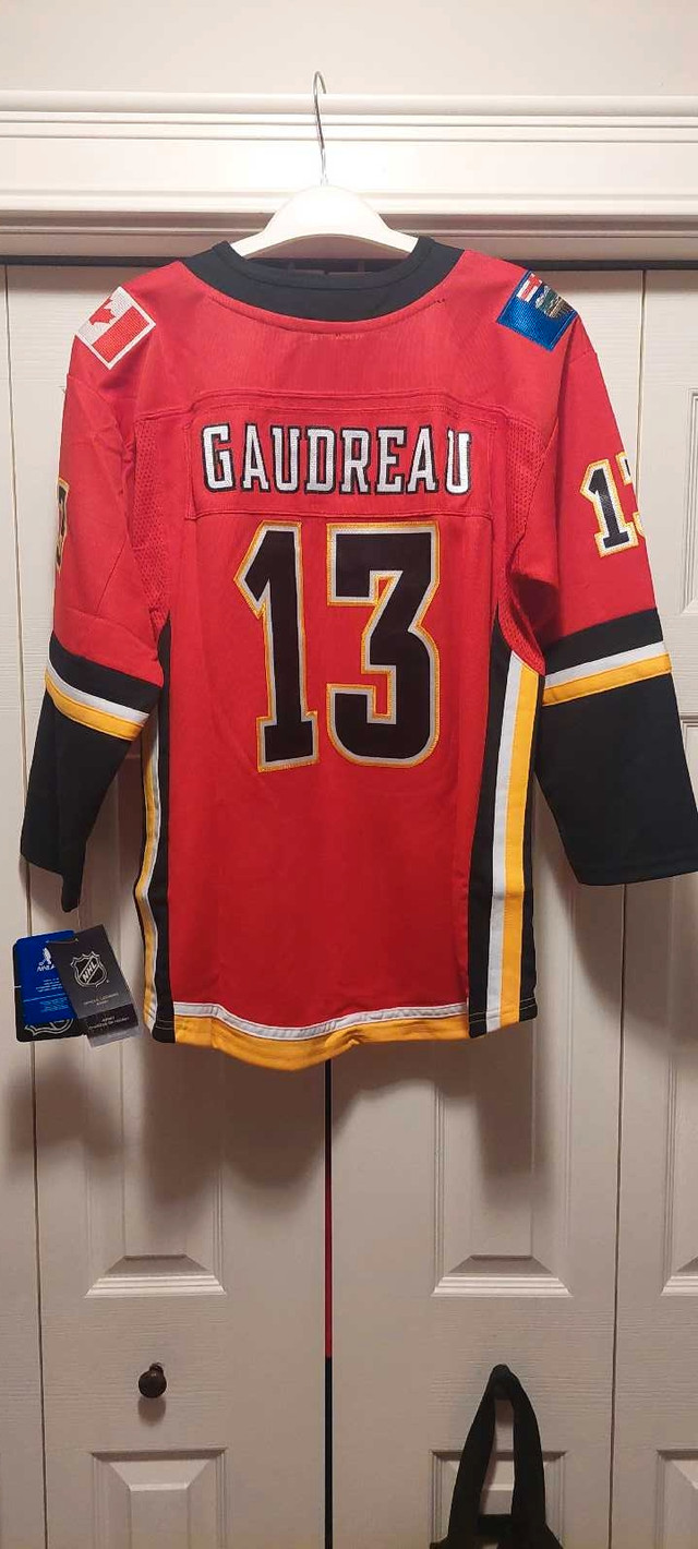 Licensed Gaudreau Calgary Flames jersey, new w/$130 tags, $65 in Hockey in Calgary