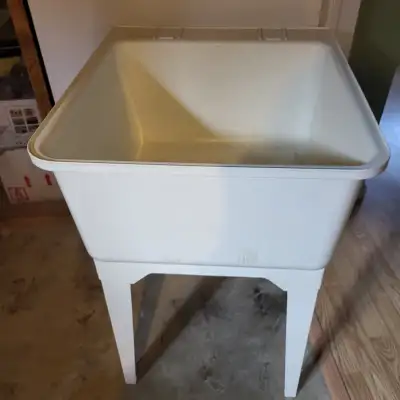 Selling a large plastic laundry tub that stands on 4 detachable legs. It is 20 1/2 inches wide and 2...