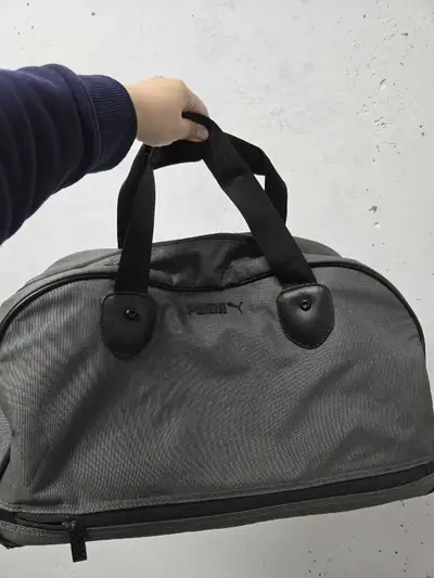 This is a Puma gym bag, perfect for carrying all your workout essentials! The bag is durable and sty...