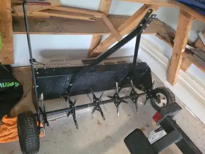 Aerate your lawn with this tow-behind aerator, featuring a durable construction and spiked rollers f...