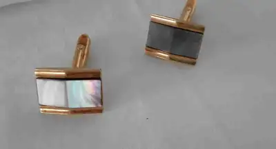 These men's cufflinks feature a rectangular design with gold trim, showcasing black and mother-of-pe...