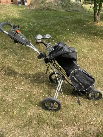 Golf clubs and hand cart, View more