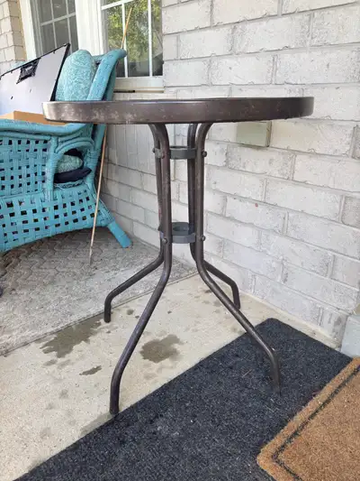 This round metal side table is perfect for a patio, deck, or small space, offering a blend of functi...
