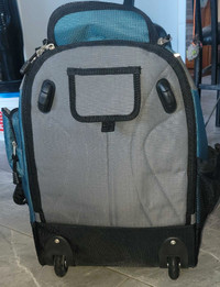 Large backpack with wheels on bottom With adjustable handle.