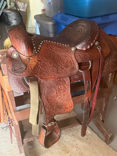 Assorted tack. Easy rider saddle 625. Circle Y 550. both 15”. various bridles and halters. Trailer t...