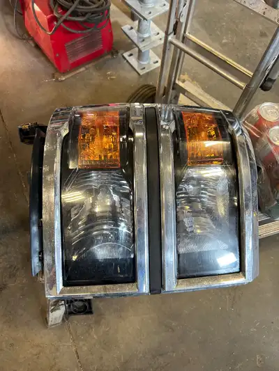 LH headlight has busted glass on lower portion and some corrosion on the chrome. RH headlight has so...