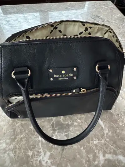 Black leather Kate spade Bag in great shape and lots of room. Medium size with a front zipper spot t...