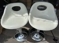 2 white collapsable chairs 