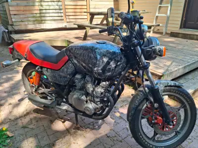 This 1982 Suzuki Katana 550 is a classic street motorcycle featuring a distinct custom marble-effect...