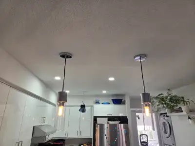 Pair of chrome & glass pendant lights, View more