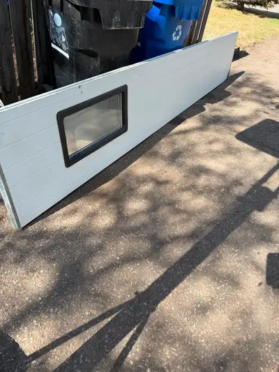 8 — 12’ x 24” garage door panels One panel has a window and one has bottom of door rubber seal One p...