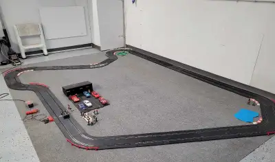 170 ft of strombecker track, several power packs and controllers. Strombecker cars, Scalextric and h...