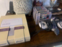 Super Nintendo, two controllers and games