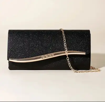Elevate your evening ensemble with this elegant black sparkly clutch featuring a chic gold-tone clas...