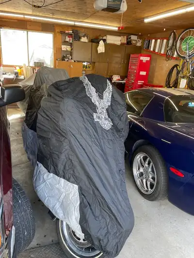 Have a brand new Harley Davidson Touring Motorcycle cover. Unsure of dimensions, but it fits over a...